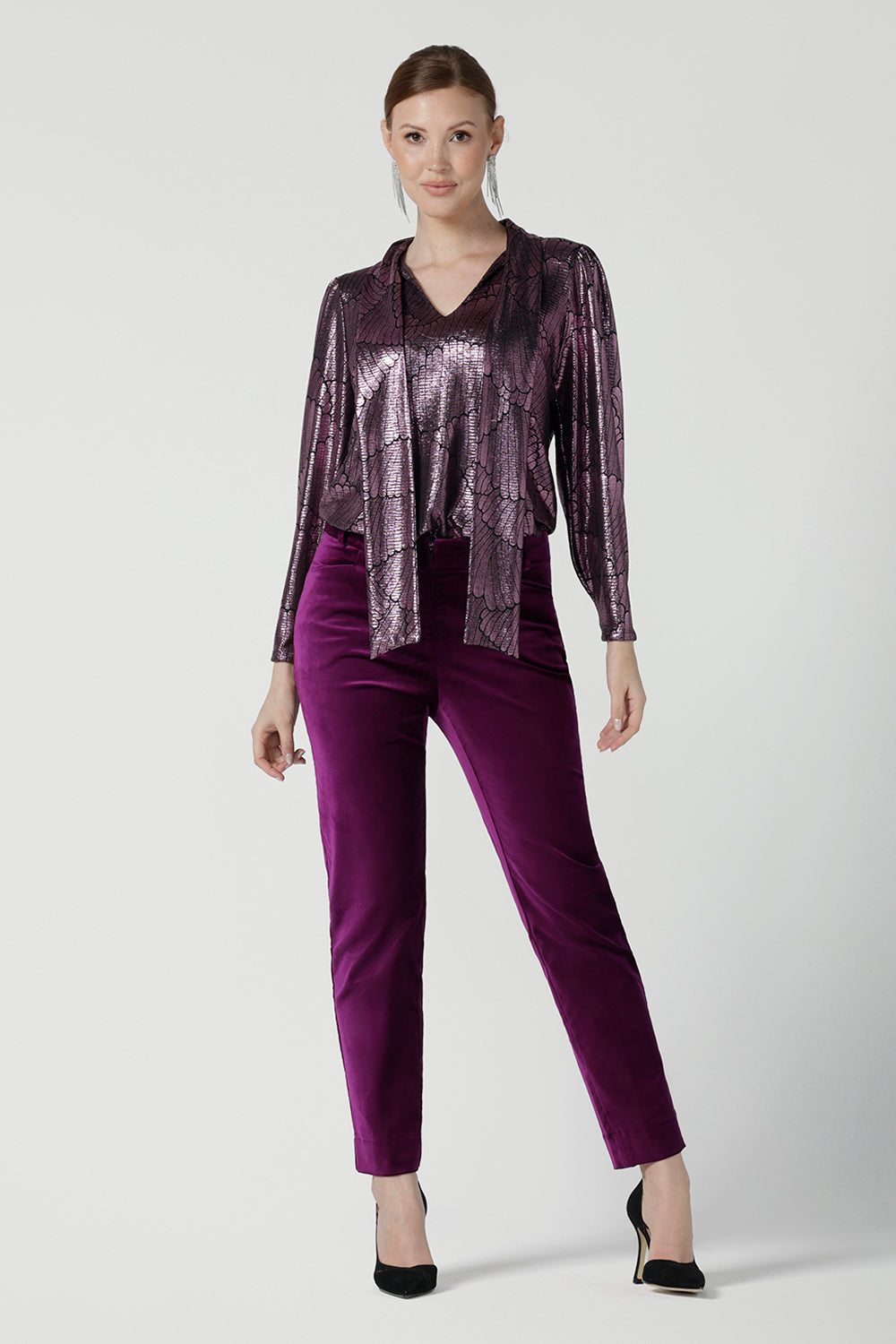 A size 10 woman wears the Keaton Pant in Magenta velveteen. Stylish up late evening wear. Size 10 up late. 