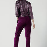 Back view of a size 10 woman wears the Keaton Pant in Magenta velveteen. Stylish up late evening wear. Size 10 up late.