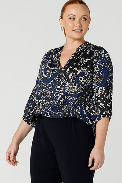 Close up of A size 12 woman wearing an animal print woven top with a swing back. This lightweight top is comfortable for your everyday workwear, casual and travel capsule wardrobe. Shop this Australian-made shirt online in sizes 8 to 24, petite to plus sizes.