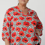 The high-low hem adds a modern edge, while the 3/4 length sleeves with soft pleats at the bound edge provide a feminine and slightly structured finish. Available in sizes 8-24.