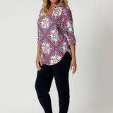 The shirt is designed with a flattering V-neckline that adds a touch of femininity and elongates the neck, making it perfect for warmer weather. The 3/4 sleeves are relaxed and slightly billowy, offering a gentle, airy feel, while the swing-style cut creates a flattering, easy fit that skims over the body, giving the shirt a relaxed yet polished silhouette.