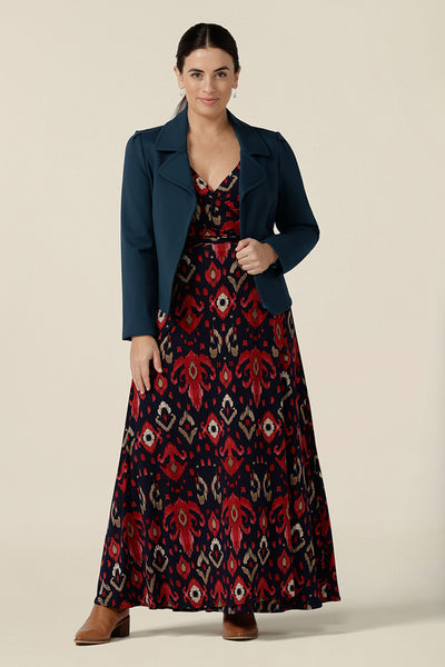 A great maxi dress, the Kimberly Maxi Dress in Ikat is a full length jersey wrap dress with long sleeves. Shown on a size 10 woman, this maxi dress is worn with a tailored blue jacket as a winter maxi dress.  Made in Australia in sizes 8 to 24.