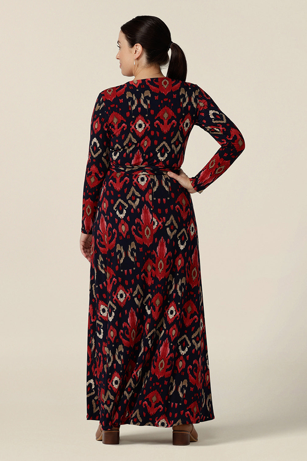 Back view of printed maxi dress, the Kimberly Maxi Dress in Ikat is a full length jersey wrap dress with long sleeves. Shown on a size 10 woman, this maxi dress is made in Australia in sizes 8 to 24.