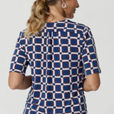 The shirttail hemline gives the top a polished, modern finish, whether tucked into high-waisted pants or skirts for a professional look or worn untucked for a more relaxed vibe. Available in sizes 8-24, the Kodi Top in Ocean is designed to flatter a variety of body types and pairs perfectly with our blazers for seamless style from office to evening. 