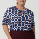 Woman's workwear shirt features lux tailored details including; soft gathers at the front, under the shoulder yoke, and at the centre-back, to create a feminine and flattering silhouette. Workwear essential is made from easy care dry touch jersey in size 8-24.