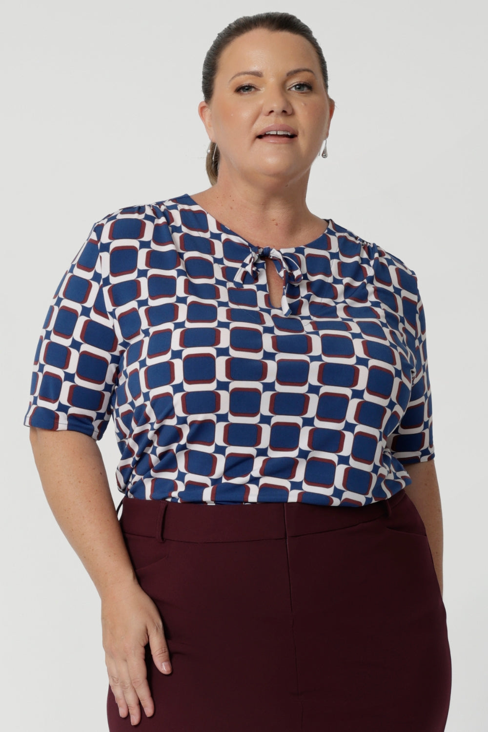 Woman's workwear shirt features lux tailored details including; soft gathers at the front, under the shoulder yoke, and at the centre-back, to create a feminine and flattering silhouette. Workwear essential is made from easy care dry touch jersey in size 8-24.