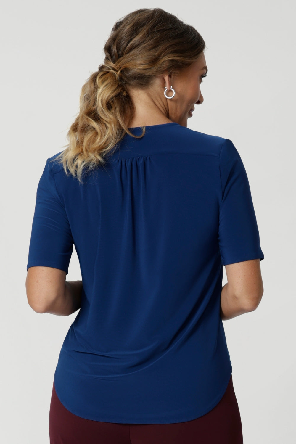 It's fluid drape and soft feel make it a versatile piece that effortlessly transitions from work wear to casual wear. Shop women's workwear basics and essentials in sizes 8-24. Easy care blouse features elbow length sleeves, tailored details and shirt tail hem.