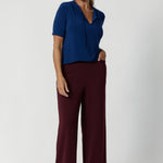 The top features elbow-length sleeves, offering just the right amount of coverage while maintaining a relaxed, airy vibe. The subtle stitching detail around the front-facing and thin fabric ties add a chic, tailored touch, while the soft gathers at the front.