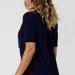 Subtle soft gathers at the front under the shoulder yoke and at the centre-back create a gentle, feminine shape, enhancing the top's overall fit without compromising on comfort. The shirttail hemline provides a clean, polished finish, making it easy to tuck in or leave out depending on your style preference.