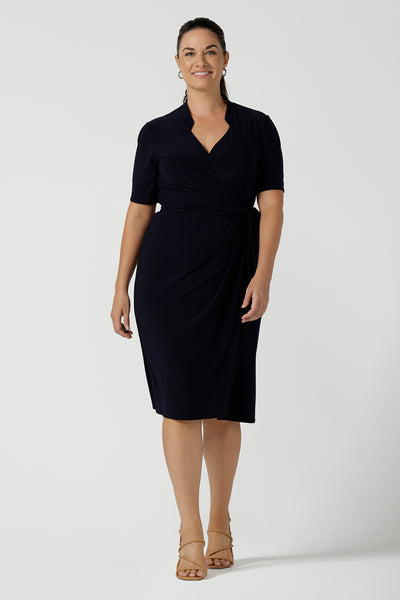 Kade dress in Navy is a functioning wrap dress in navy. Featuring a mandarin collar and short sleeves. Gathered at the waist with a functioning tie. Made in Australia for women size 8 - 24.