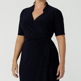 Kade dress in Navy in s a size 12 is a functioning wrap dress in navy. Featuring a mandarin collar and short sleeves. Gathered at the waist with a functioning tie. Made in Australia for women size 8 - 24.