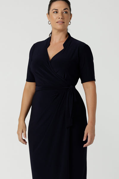 Kade dress in Navy in s a size 12 is a functioning wrap dress in navy. Featuring a mandarin collar and short sleeves. Gathered at the waist with a functioning tie. Made in Australia for women size 8 - 24.