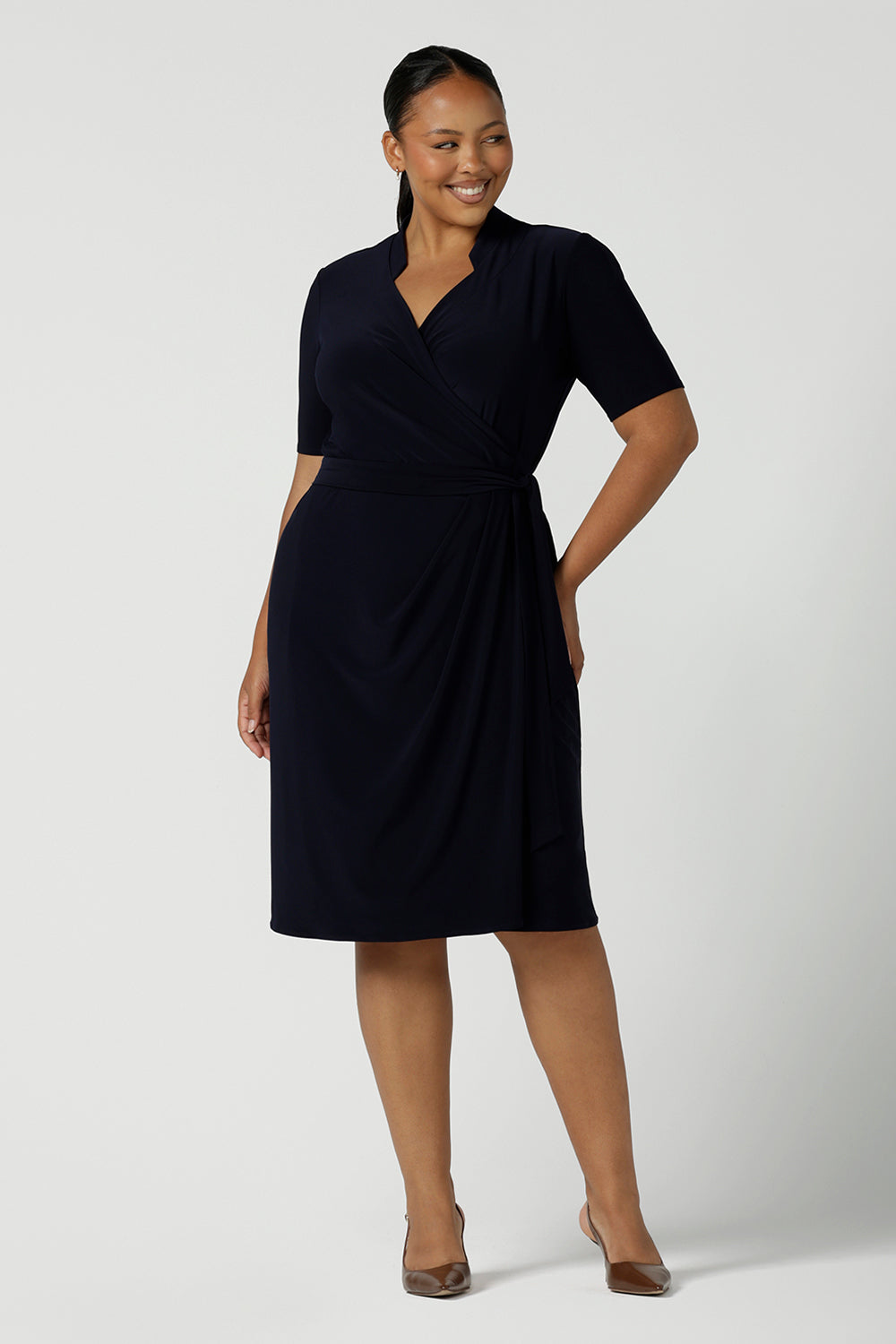 Kade dress in Navy in s a size 16 is a functioning wrap dress in navy. Featuring a mandarin collar and short sleeves. Gathered at the waist with a functioning tie. Made in Australia for women size 8 - 24.