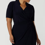 Kade dress in Navy in s a size 16 is a functioning wrap dress in navy. Featuring a mandarin collar and short sleeves. Gathered at the waist with a functioning tie. Made in Australia for women size 8 - 24.