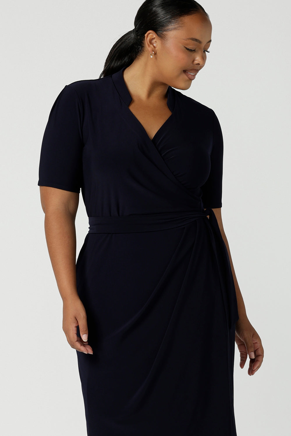 Kade dress in Navy in s a size 16 is a functioning wrap dress in navy. Featuring a mandarin collar and short sleeves. Gathered at the waist with a functioning tie. Made in Australia for women size 8 - 24.