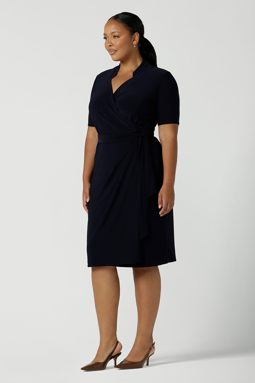 Kade dress in Navy in s a size 16 is a functioning wrap dress in navy. Featuring a mandarin collar and short sleeves. Gathered at the waist with a functioning tie. Made in Australia for women size 8 - 24.