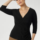 Designed with a fixed wrap bodice that stays perfectly in place, this top offers the elegance of a wrap style without the need for constant adjustment. Whether you're in the office or heading to after-work events.