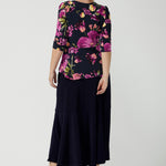 Back view of a size 10 woman wears the Celeste Top and Navy Berit Maxi Skirt. A beautiful fixed wrap top with a peplum and shoulder sleeeve tuck with 3/4 sleeves. Made in Australia for women size 8 - 24.