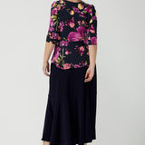 Back view of a size 10 woman wears the Celeste Top and Navy Berit Maxi Skirt. A beautiful fixed wrap top with a peplum and shoulder sleeeve tuck with 3/4 sleeves. Made in Australia for women size 8 - 24.