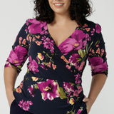 Size 18 woman wears the Celeste Top  and Navy monroe pant. A beautiful fixed wrap top with a peplum and shoulder sleeeve tuck with 3/4 sleeves. Made in Australia for women size 8 - 24. 