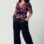 Size 18 woman wears the Celeste Top and Navy monroe pant. A beautiful fixed wrap top with a peplum and shoulder sleeeve tuck with 3/4 sleeves. Made in Australia for women size 8 - 24.