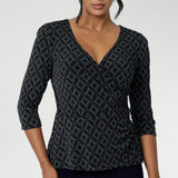 The Kyle Top is the perfect blend of professional style and all-day comfort, designed to keep you looking polished without sacrificing ease. Crafted from a black dry-touch jersey fabric with a soft stretch, this top features a fixed wrap-front bodice that stays perfectly in place, providing a flattering and secure fit. Available in size 8-24. 