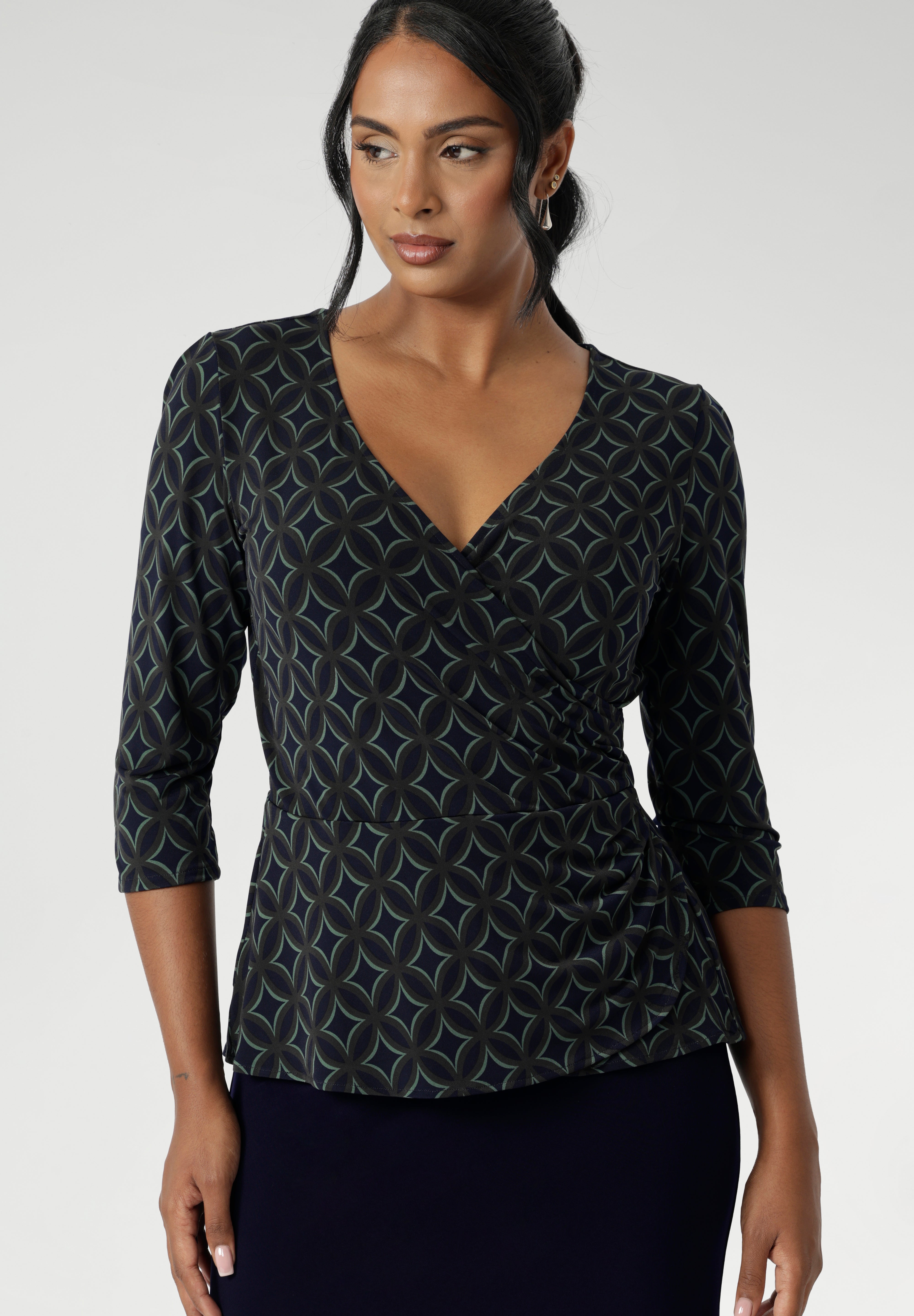 The double-layer back bodice adds extra structure, while the 3/4 length sleeves offer an elegant touch. The waist seam and soft peplum detail, which flows through both the front and back, add sophistication and can easily be tucked into high-waisted pants for a chic, versatile look. 