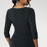 The waist seam and soft peplum detail, which flows through both the front and back, add sophistication and can easily be tucked into high-waisted pants or out over skirts and pants.