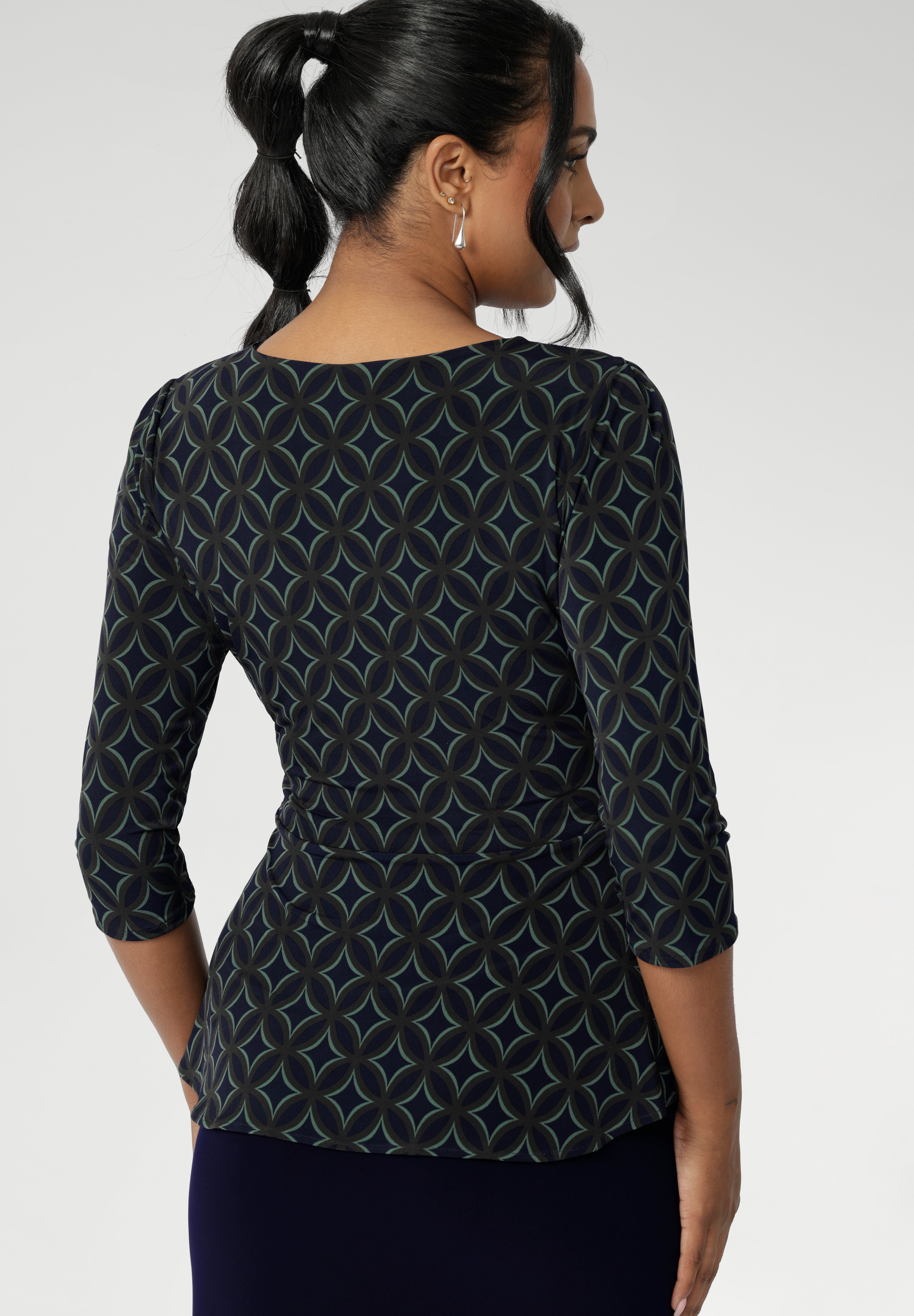 The waist seam and soft peplum detail, which flows through both the front and back, add sophistication and can easily be tucked into high-waisted pants or out over skirts and pants.