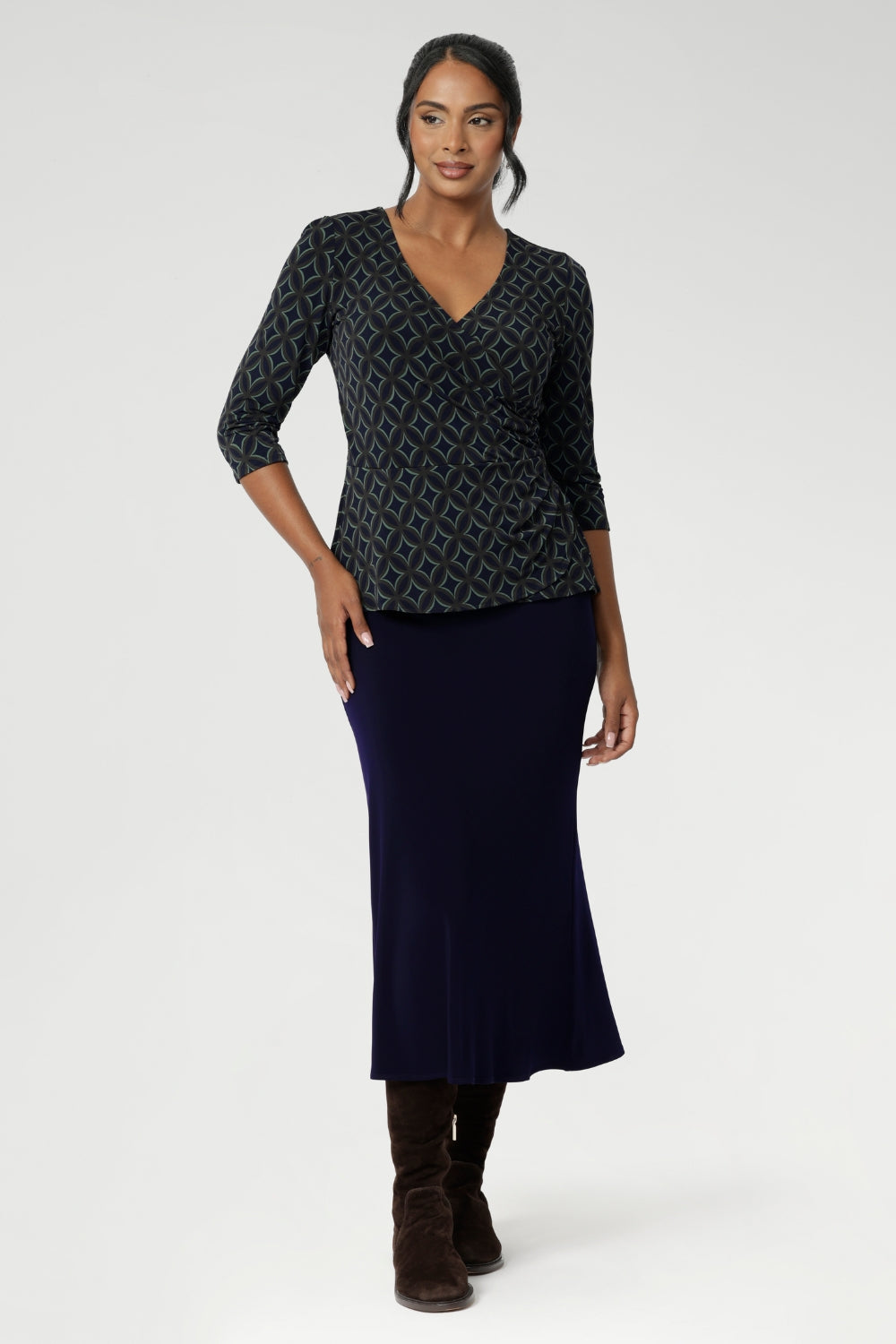 The Kyle Top combines professional sophistication with all-day comfort, crafted for a flawless fit and versatile styling. Made from a navy dry-touch jersey fabric with soft stretch, this top features a fixed wrap-front bodice that stays securely in place, offering a flattering and tailored look. 