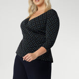 The double-layer back bodice adds extra structure, while the 3/4 length sleeves offer an elegant touch. Proudly made in Australia, the Kyle Top is available in sizes 8 to 24, designed to flatter both petite and plus-size women. Size 18 woman wears her Kyle Top over some Navy Workwear pants. 