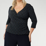 The Kyle Top is the perfect blend of professional style and all-day comfort, designed to keep you looking polished without sacrificing ease. Crafted from a printed dry-touch jersey fabric with a soft stretch, this top features a fixed wrap-front bodice that stays perfectly in place, providing a flattering and secure fit.