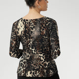 The Kyle Top in Panthera—a bold cheetah print—features a fixed wrap bodice that stays perfectly in place, offering the elegance of a wrap design without the need for constant adjustment.
