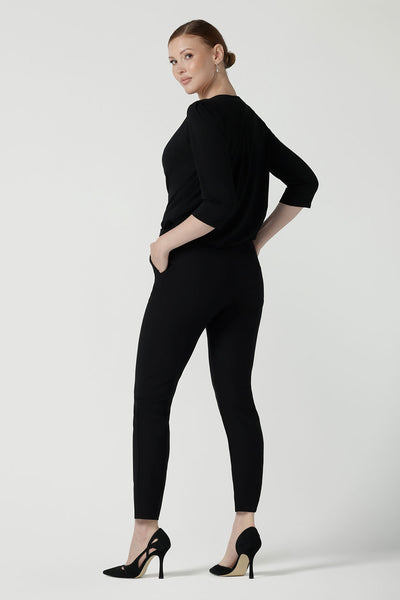 Back view of the Kyrie top of a size 10 woman wears the Kyrie Top in Black bamboo. A bamboo top made in Australia for women. Made in Australia size 8 - 24.