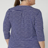 Close up image of plus size model wears workwear top that features curved shirt-tail hemline that gives this top a polished, contemporary finish, offering versatility for both tucked and untucked styles. Sizes 8-24 available.