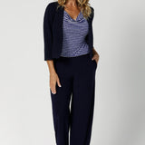 Tailored specifically for the modern woman on the go, this top is an essential addition to any workwear clothing capsule. Size 12 woman wears polka dot printed top with matching navy suiting for an elevated corporate look.