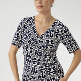 Designed for seamless transitions from the office to evening events and weekend outings, this versatile dress features a flattering fixed wrap bodice, a sophisticated knee-length tulip skirt, and above-elbow sleeves that strike the perfect balance between coverage and style.