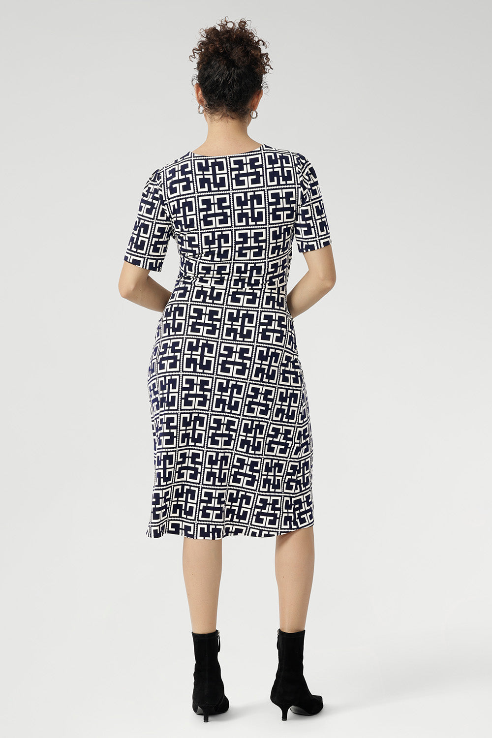 Step into effortless elegance with the Leah Dress, made from our signature dry-touch stretch jersey that combines comfort, style, and versatility. Perfect for any occasion—from the office to special events to relaxed weekend outings—this beautifully tailored dress features a fixed wrap front bodice that enhances the silhouette, a flattering knee-length tulip skirt, and refined above-elbow sleeves.