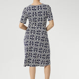 Step into effortless elegance with the Leah Dress, made from our signature dry-touch stretch jersey that combines comfort, style, and versatility. Perfect for any occasion—from the office to special events to relaxed weekend outings—this beautifully tailored dress features a fixed wrap front bodice that enhances the silhouette, a flattering knee-length tulip skirt, and refined above-elbow sleeves.