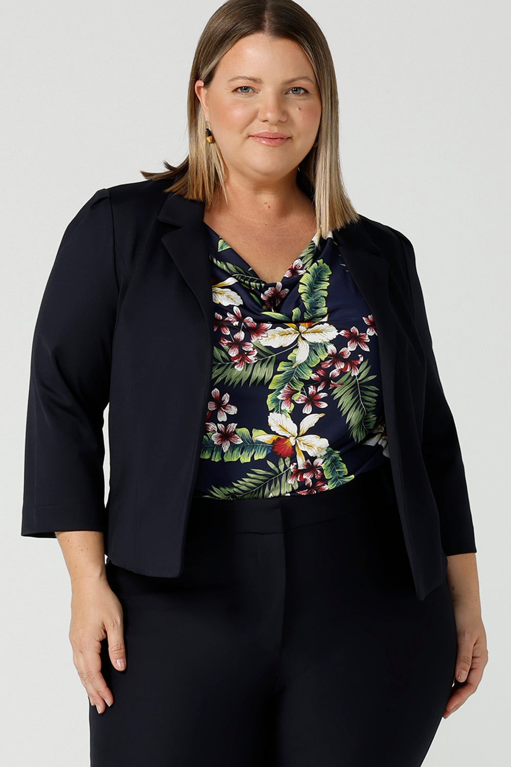 A curvy size 18 woman wears a tailored navy Lenni Jacket in Ponte. A tailored jacket for work in deep navy. Comfortable workwear for women sizes 8 - 24. 