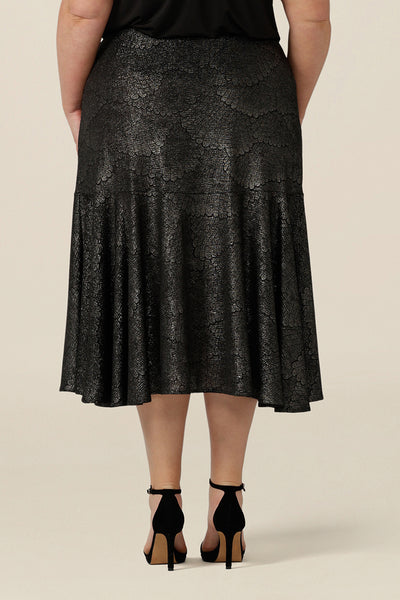 Back view of a midi length, foil print evening skirt with ruffle hem in plus size. For cocktail and evening wear, this elegant skirt is made in Australia by women's fashion brand, Leina & Fleur. Shop their evening and cocktail wear online in sizes 8 to 24.