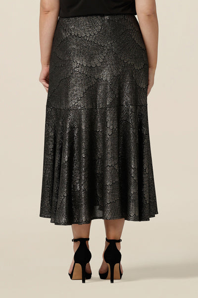 Back view of a midi length, foil print evening skirt with ruffle hem. For cocktail and evening wear, this elegant skirt is made in Australia by women's fashion brand, Leina & Fleur. Shop their evening and cocktail wear online in sizes 8 to 24.