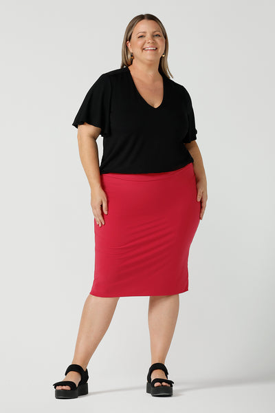 A flutter sleeve, black top for work and casual wear, this tailored top is worn by a size 18 curvy woman. Made in Australia, shop women's black tops online at Australian and New Zealand women's clothing brand, Leina & Fleur.