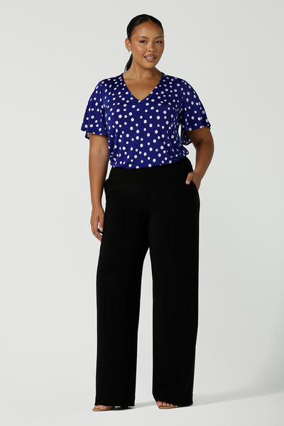 Lila Top in Cobalt spot, V-Neckline with flutter sleeves and a curved hemline. Styled back with black Monroe Pants. Comfortable corporate wear for women.Solf silky jersey and made in Australia for women size 8 - 24.