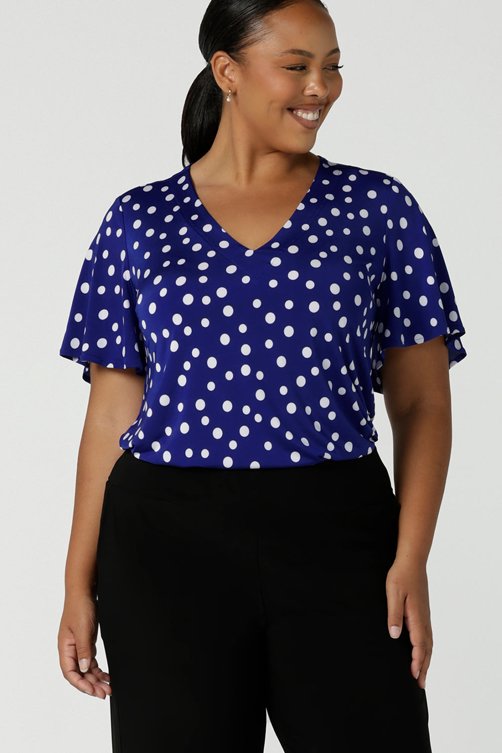 Lila Top in Cobalt spot, V-Neckline with flutter sleeves and a curved hemline. Solf silky jersey and made in Australia for women size 8 - 24.
