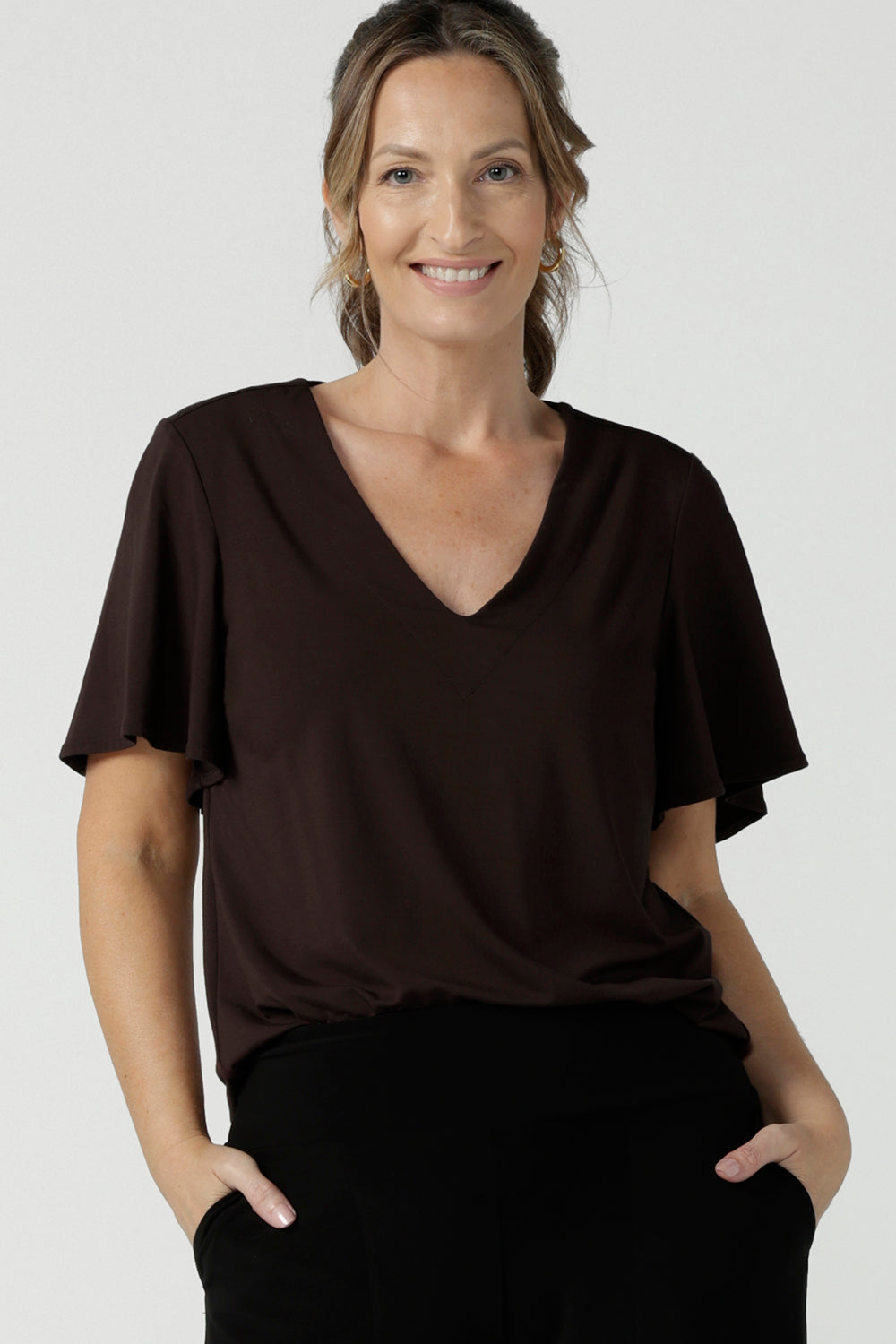 Women's breathable bamboo top for petite to plus size curvy women size 8-24. Ladies top for comfortable corporate wear. Featuring a flutter sleeve, V-neckline and curved hemline. 