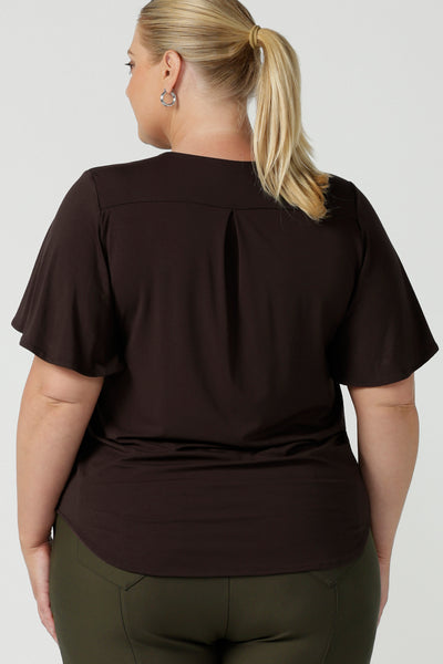 Back view of women's breathable bamboo top for petite to plus size curvy women size 8-24. Ladies top for comfortable corporate wear. Featuring a flutter sleeve, V-neckline and curved hemline. Pictured on a size 18