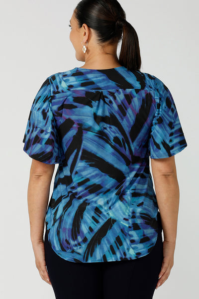 Back view of a size 12 woman wearing a Lila printed top in Flutter print. Digitally printed with cobalt, purple and black on a butterfly wing abstract print. Made in Australia for women 8 - 24.