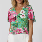 This floral printed top is an elegant and versatile piece, perfect for the event season. Designed with a flattering V-neck, it creates a graceful neckline, while the flutter sleeves add a feminine, airy touch. The shirt tail hemline offers a relaxed yet polished silhouette, ideal for pairing with everything from tailored pants to skirts. Made of soft, breathable slinky jersey fabric, this top drapes beautifully, offering a comfortable and chic fit. Sizes 8-24 now available.