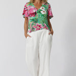 This floral printed top is an elegant and versatile piece, perfect for the event season whether dressed up or worn casually. Featuring flattering V-neck and flutter sleeves to add a feminine, airy touch. The shirt tail hemline offers a relaxed yet polished silhouette, ideal for pairing with everything from tailored pants to skirts. Easy care top drapes beautifully, offering a comfortable and chic fit due to its slinky jersey fabric design.